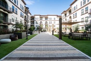 Central courtyard with bbqs, fireplace, outdoor kitchen and green space for recreation